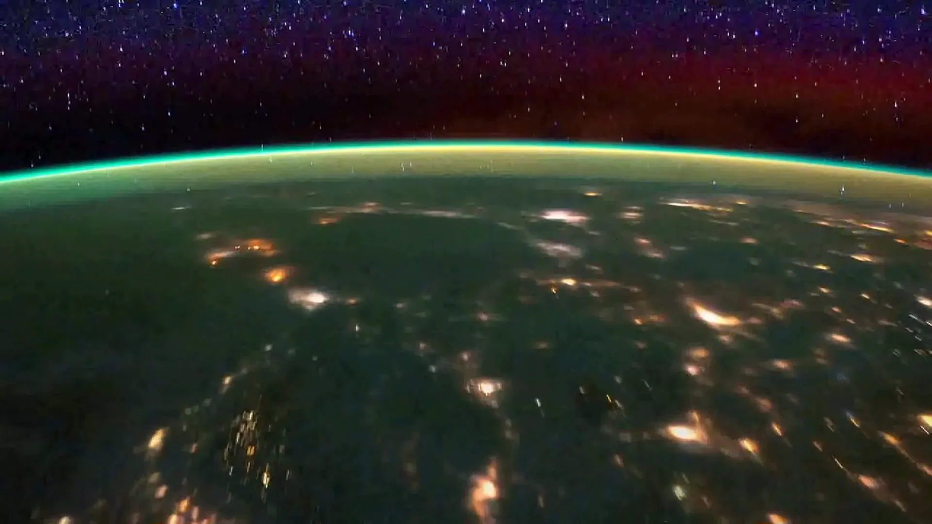 Earth's limb at night seen from the ISS, with the green airglow line of the upper atmosphere